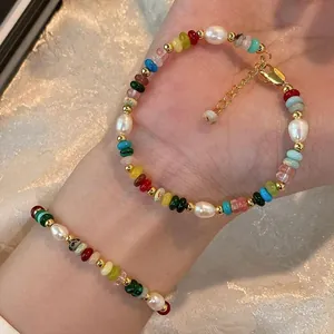 Detailed close-up showing rainbow natural stone beads and rice freshwater pearls on a bracelet