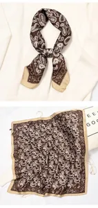 Detail view of a brown paisley silk square scarf used as a decorative neckerchief