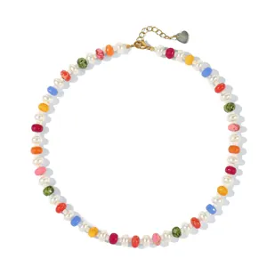 Detailed view of vibrant rainbow chalcedony beads and delicate gold heart charm