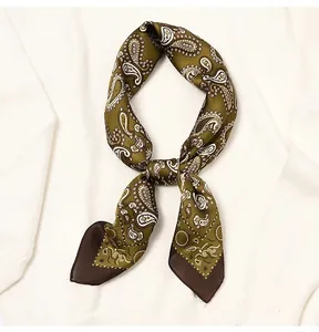 Elegant vintage paisley olive green silk square scarf styled on a white sweater.