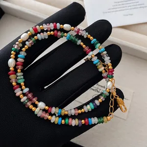 Close-up detail of a colorful rainbow natural stone and rice freshwater pearl necklace