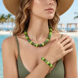 Close-up of green resin beaded necklace and bracelet set worn for summer beach vacation.
