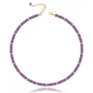 Detailed macro view of purple natural stone bead necklace featuring golden spacers