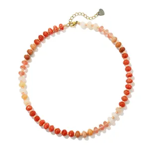 Detailed view of a colorful chalcedony bead necklace with a gold chain and heart charm