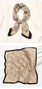 Detailed macro view of vintage paisley pattern print on golden silk square neck scarf
