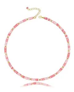 Detail shot of a gradient pink natural stone bead necklace with golden metal spacers.