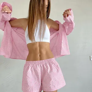 Women's pink and white gingham pajama set with long-sleeved shirt and elastic shorts
