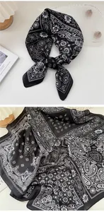 Macro view of vintage black and white paisley floral pattern on silk scarf fabric