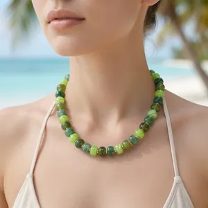 Close-up of vibrant green resin bead necklace on woman at a sunny beach resort