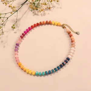 Close-up of rainbow chalcedony abacus bead necklace with a gold heart charm