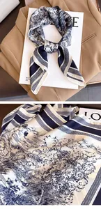 Close-up detail of a navy blue vintage patterned silk scarf draped over a beige blazer