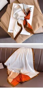 Detail view showing the retro geometric pattern and silky texture of the square neck scarf