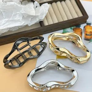 Large set of three irregular wavy metal hair claw clips in gold silver and gunmetal