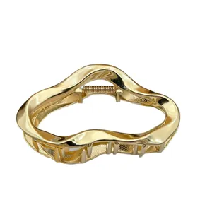 Elegant golden irregular wave metal hair claw clip with a polished finish for women