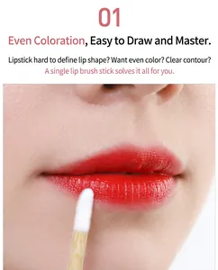 Macro view of a disposable bamboo lip brush applying red lipstick to a model's lips