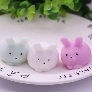 Close-up of three cute colorful rabbit mochi squishy stress relief toys on a plate
