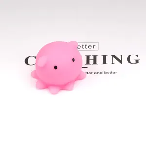 Macro view of a soft pink octopus squishy toy on a white background.