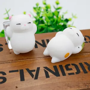 Detailed macro view of cute white cat TPR squishy decompression toys on a rustic wooden box