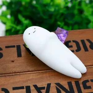 Cute white TPR ghost squishy toy for stress relief on wooden background