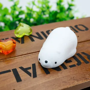 Macro view of a cute white polar bear TPR squishy fidget toy on a rustic wooden background