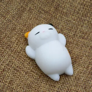 Close-up of a cute white cat TPR squishy stress relief toy on a textured burlap background