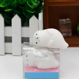 Close-up of a soft white TPR seal squishy toy for stress relief in a clear display box