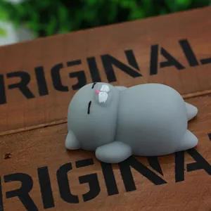 Detailed view of a cute grey cat-shaped TPR squishy stress relief toy on a wood.