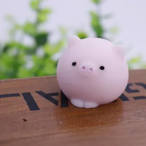 Detailed view of a cute pink pig squishy stress relief toy on a wooden surface