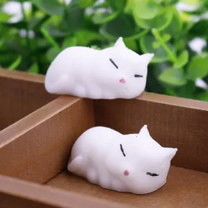 Detailed view of two cute white cat squishy toys for stress relief and sensory play.