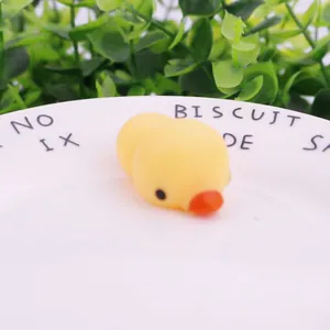 Close-up of a cute yellow duck squishy decompression toy on white plate.