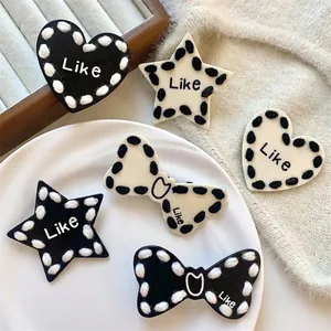 Stylish black and white star heart bow hair clips with contrast knit edges set.