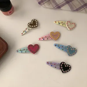 Set of 6 colorful heart hair clips featuring polka dots and LOVE text engraving