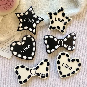 Stylish black and white star heart bow hair clips with cute fuzzy yarn edges and Like text