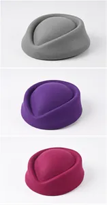 Variety of woolen pillbox stewardess hats in grey, purple, and magenta colors.