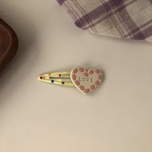 Sweet heart-shaped BB hair clip with colorful dots and LOVE engraving detail view