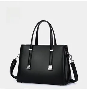 Side view of elegant black leather commuter tote handbag with silver hardware