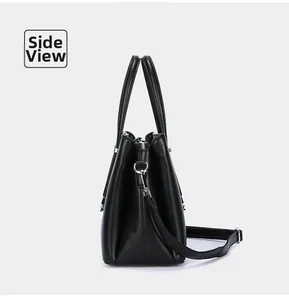 Detailed side view of a premium black leather tote bag with silver metal hardware