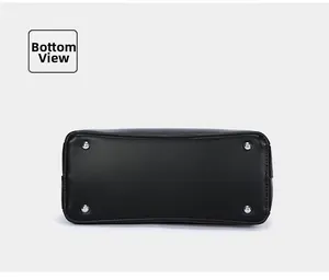 Bottom view of black leather commuter tote bag with silver metal protective feet.