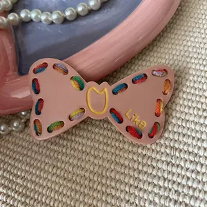 Sweet pink Y2K bow hair clip with colorful woven thread and Like text detail