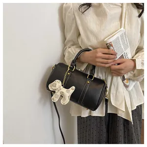 Elegant black Boston pillow bag featuring a cute white patterned puppy charm detail