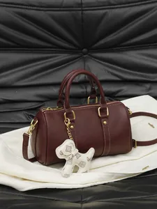 Elegant burgundy leather Boston pillow bag with cute puppy charm and adjustable shoulder strap