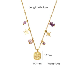 Detailed view of gold multi-pendant necklace with stars, beads and a pearl charm