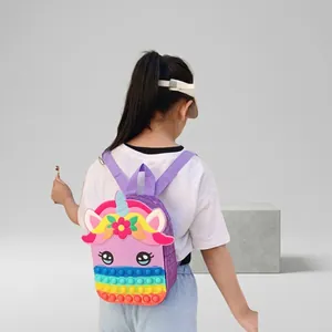 Young girl wearing a colorful silicone unicorn pop-it fidget backpack for school play