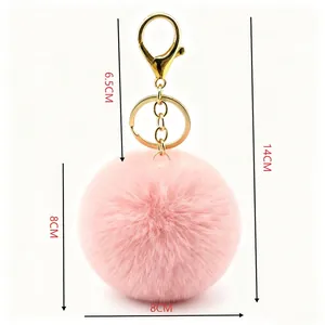 Pink faux fur pom-pom keychain with gold hardware, 8cm ball diameter, 14cm total length.