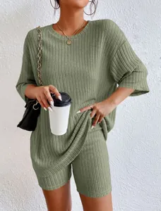Detail of women's olive green ribbed loungewear set with loose tee and biker shorts