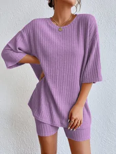 Detail view of purple ribbed lounge set featuring loose round neck top and shorts