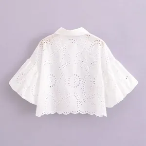 White embroidered cropped blouse featuring elegant puff sleeves and delicate eyelet lace