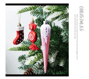 Colorful Christmas ornaments set with candy, stocking, and icicle shapes hanging on tree