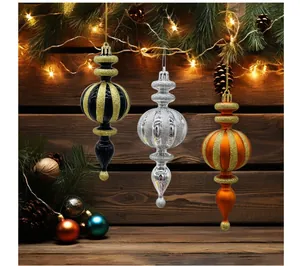 Detailed view of three festive glitter finial Christmas tree ornaments for decor