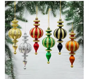 Set of elegant glittery finial Christmas ornaments hanging against a festive background
